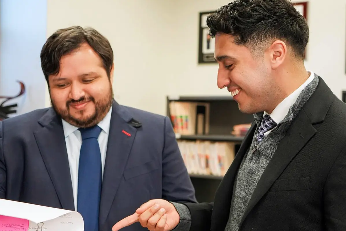 New York Spanish-speaking immigration lawyer Eliud Zavala reviewing case with client